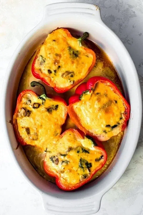 Breakfast stuffed peppers filled with eggs, cheese, and vegetables