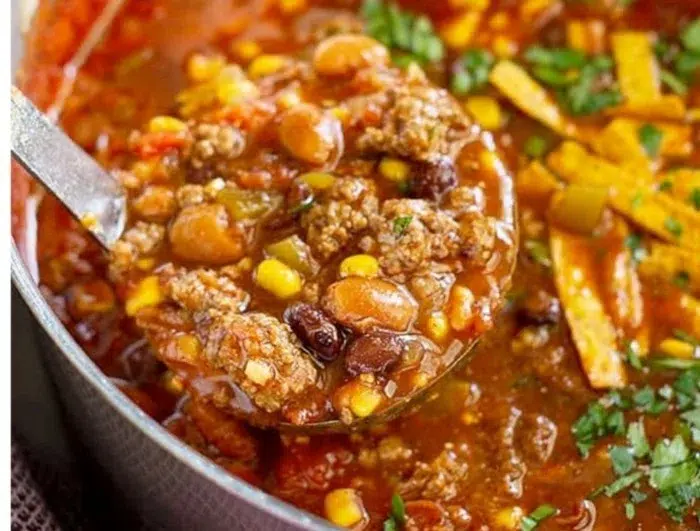 Bowl of delicious Taco Soup topped with cheese and cilantro