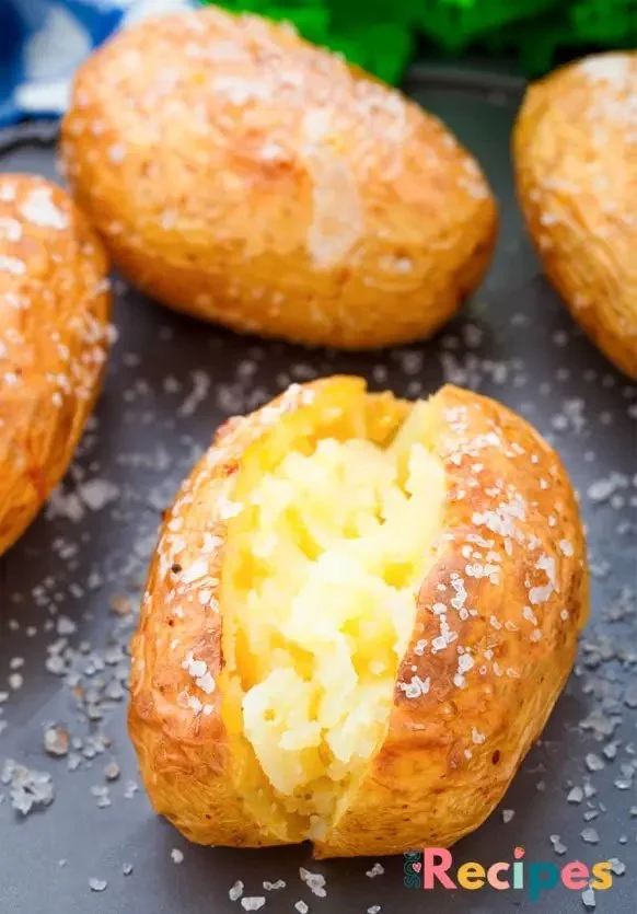 Delicious air fryer baked potatoes with crispy skin and fluffy interior.