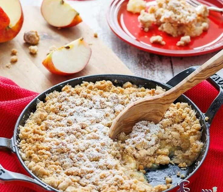 Delicious homemade Apple Crumble dessert with warm apples and crunchy topping