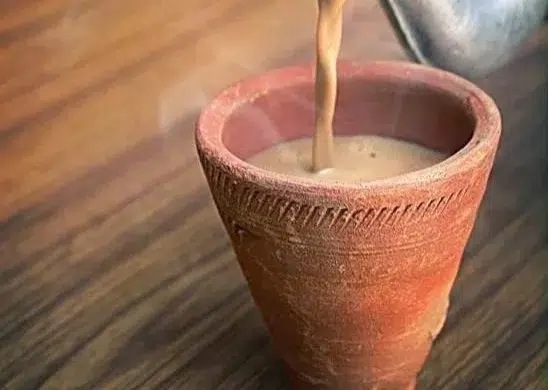 Authentic masala chai recipe with spices and tea brewing in a pot