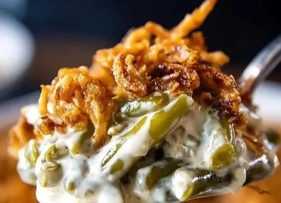 Campbell's Green Bean Casserole topped with crispy fried onions in a baking dish