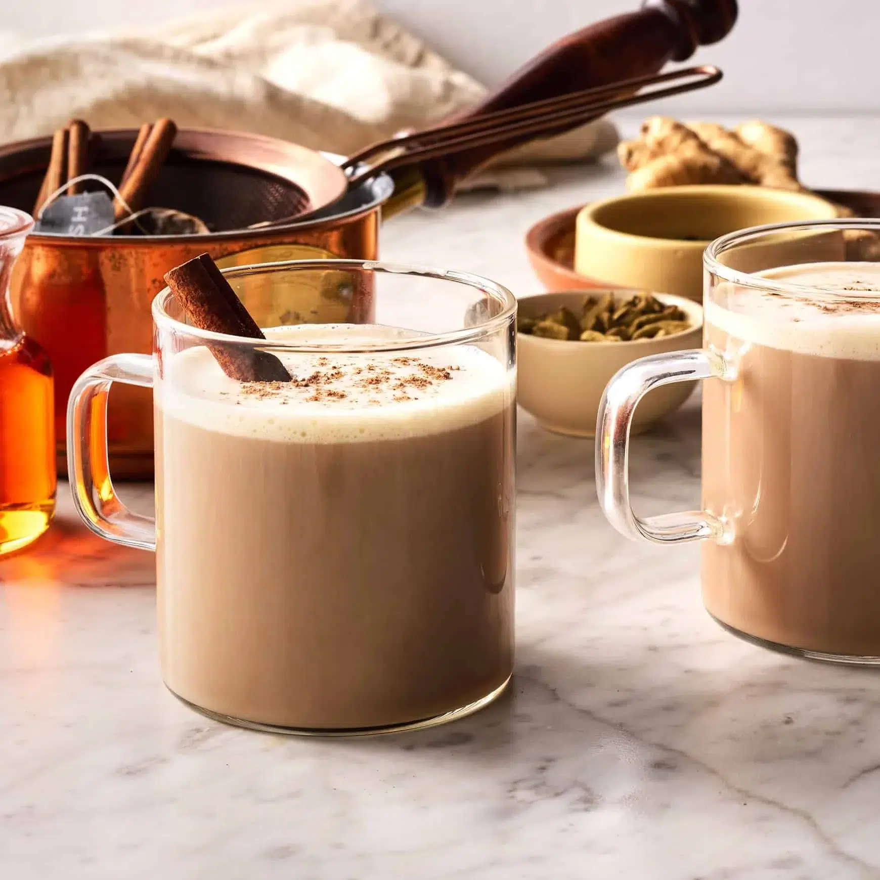 A steaming cup of chai latte with spices and milk, perfect for cozy moments.