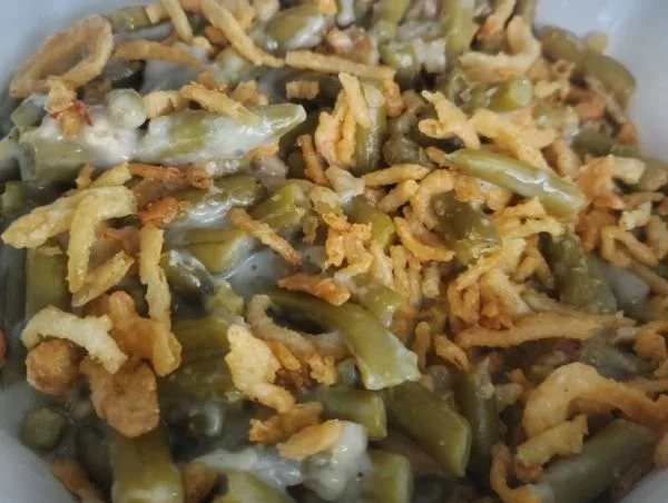 Classic Campbell's green bean casserole topped with crispy onions and creamy sauce.