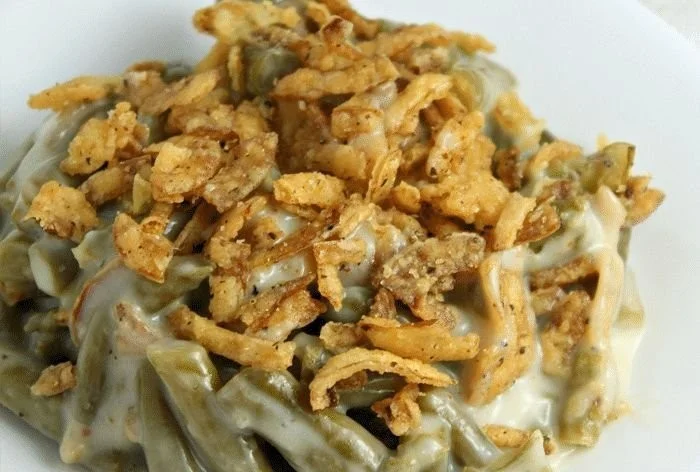 Classic green bean casserole with crispy onion topping served in a dish