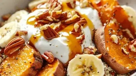 Energizing sweet potato breakfast bowl topped with nuts and fruits.
