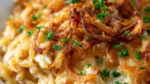 Delicious French Onion Chicken Orzo Casserole topped with melted cheese.