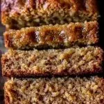 Classic moist banana bread loaf with golden crust and slices, ready to enjoy.