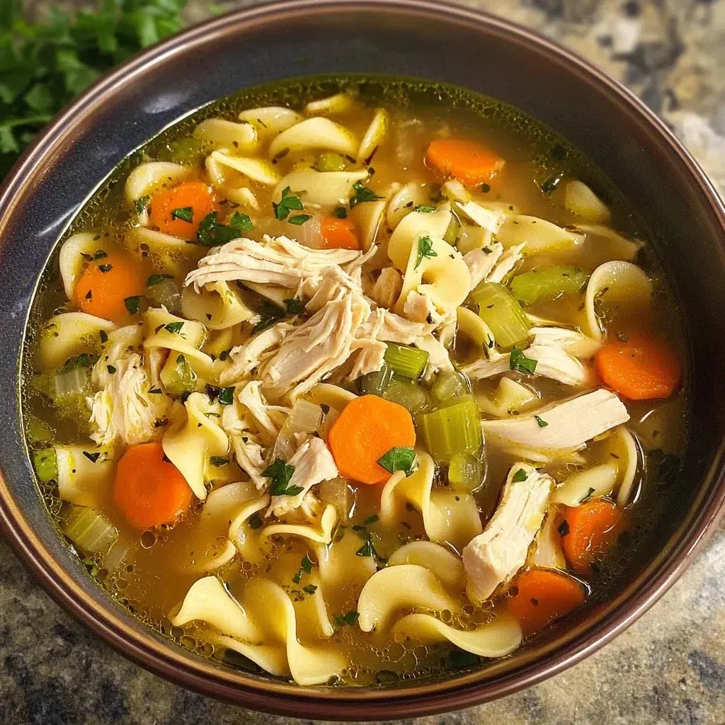 Bowl of homemade chicken noodle soup with carrots and noodles