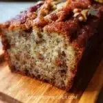 Delicious slice of the world's best banana bread on a wooden table