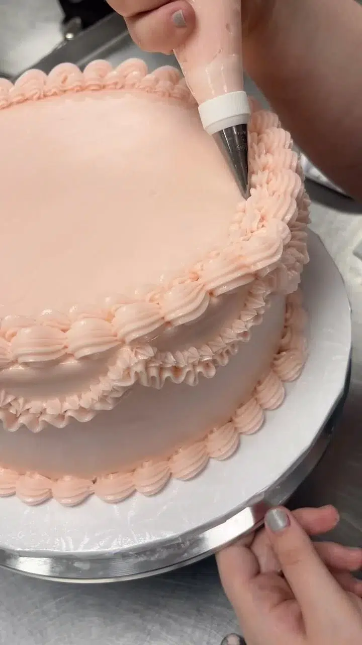 Elegant vintage cake decorated with intricate frosting details by Barnett Sweets + Co.