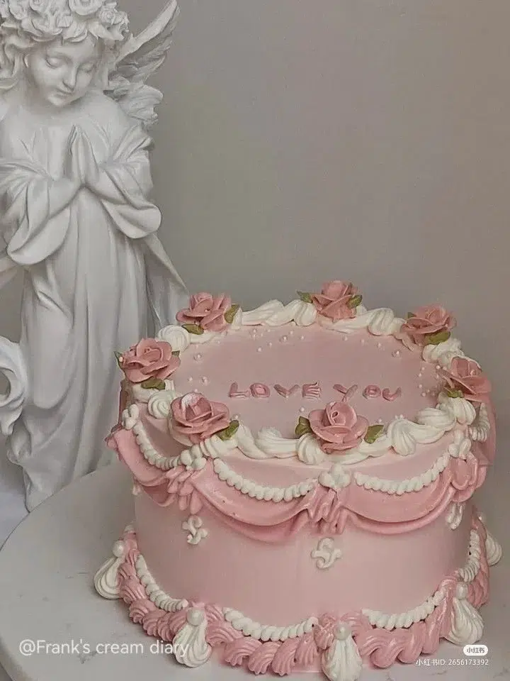 Vintage girly pink birthday cake adorned with floral decorations and elegant details.